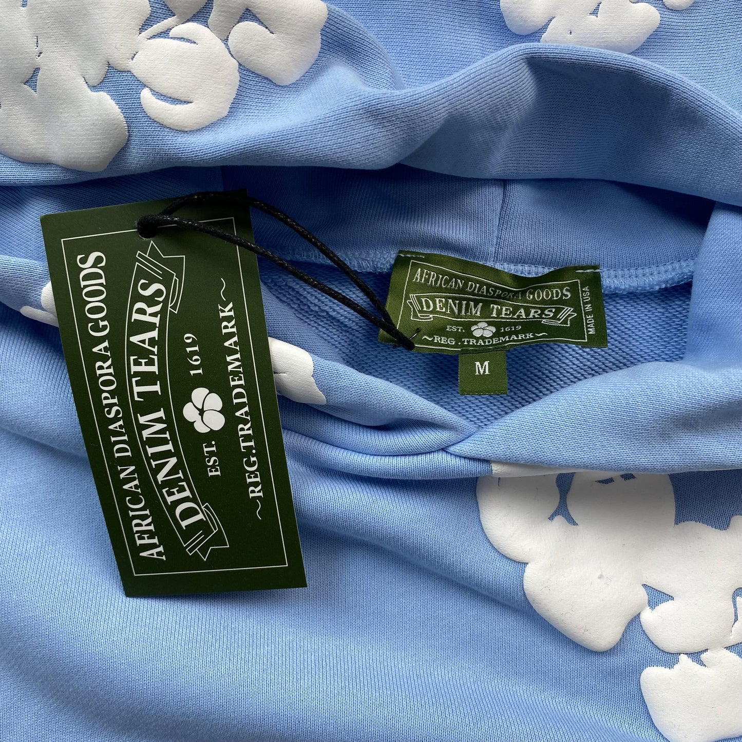 DENIM TEARS COTTON WREATH HOODIE BABY BLUE - Vanté®